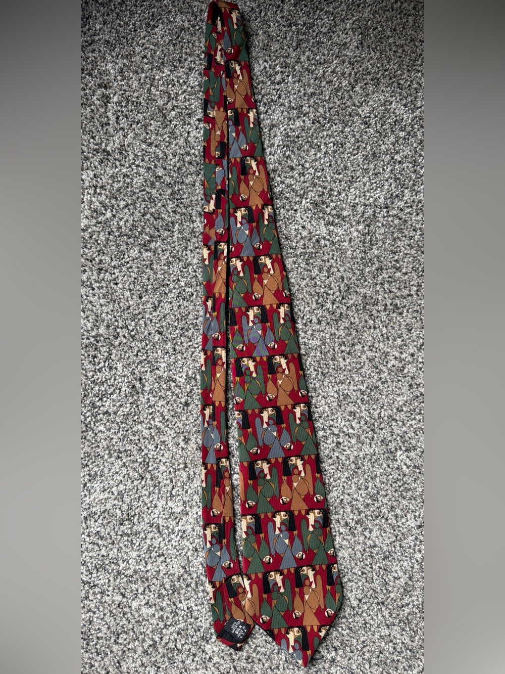 silk tie with abstract geometric pattern in red, green, and brown